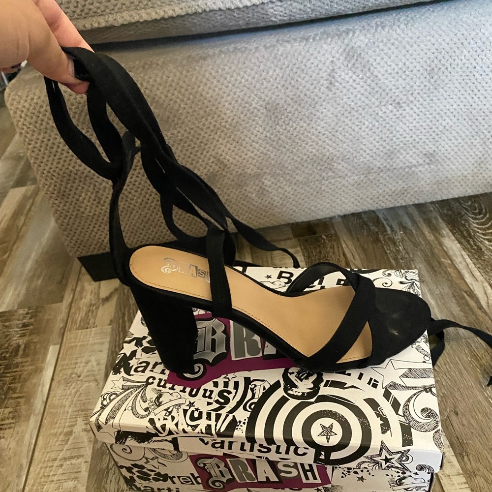 Black strapped tie around sandals